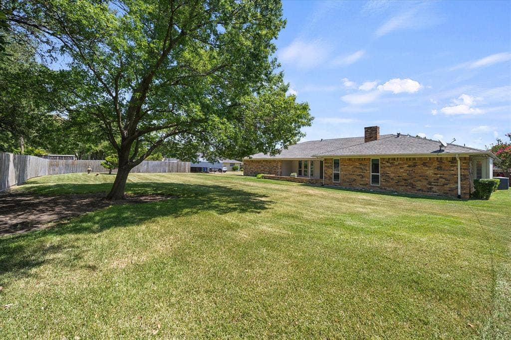 4001 Keele Drive, Garland, TX 75041 Expansive backyard with mature shade tree and plenty of room for outdoor entertaining, play, or relaxation.