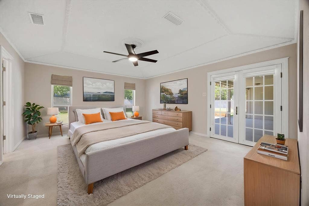 4001 Keele Drive, Garland, TX 75041 Virtually staged spacious primary bedroom featuring a tray ceiling, abundant natural light, and French doors leading to the patio.