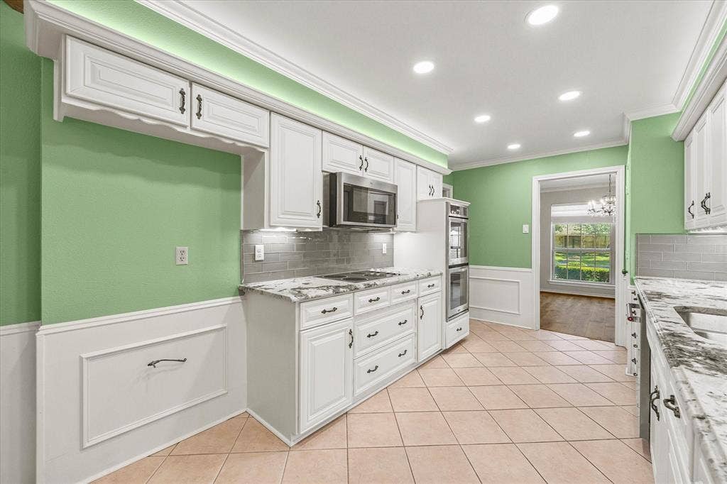 4001 Keele Drive, Garland, TX 75041 Updated appliances including double oven, dishwasher, and microwave. Electrical stove top is plumbed for gas.