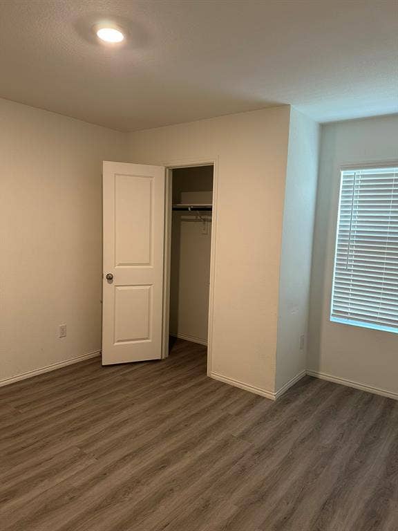 5705 Manarchos Lane, Forney, TX 75126 Unfurnished bedroom featuring dark wood-style floors and a closet