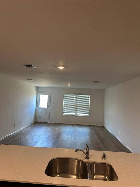 5705 Manarchos Lane, Forney, TX 75126 Kitchen with open floor plan, wood finished floors, and light countertops