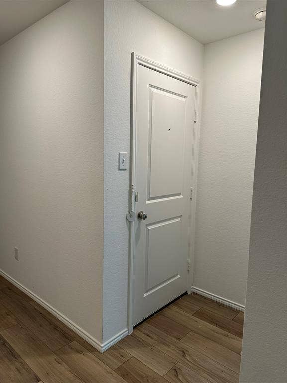 5705 Manarchos Lane, Forney, TX 75126 Doorway to outside featuring wood finished floors and a textured wall