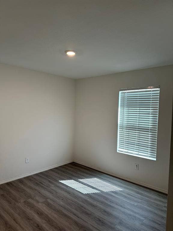 5705 Manarchos Lane, Forney, TX 75126 Unfurnished room with wood finished floors and baseboards