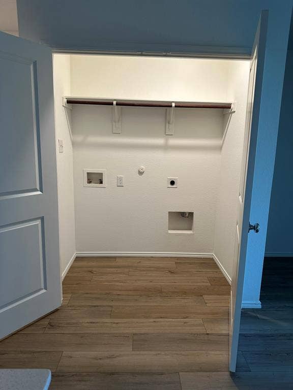 5705 Manarchos Lane, Forney, TX 75126 Laundry area featuring electric dryer hookup, hookup for a gas dryer, wood finished floors, and washer hookup