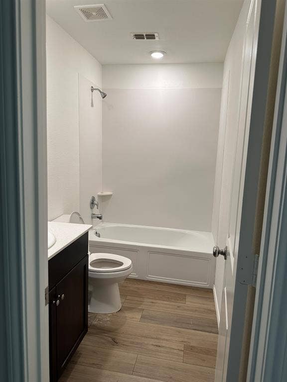 5705 Manarchos Lane, Forney, TX 75126 Bathroom with vanity, wood finished floors, and shower / tub combination