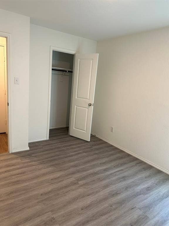 5705 Manarchos Lane, Forney, TX 75126 Unfurnished bedroom with wood finished floors and a closet