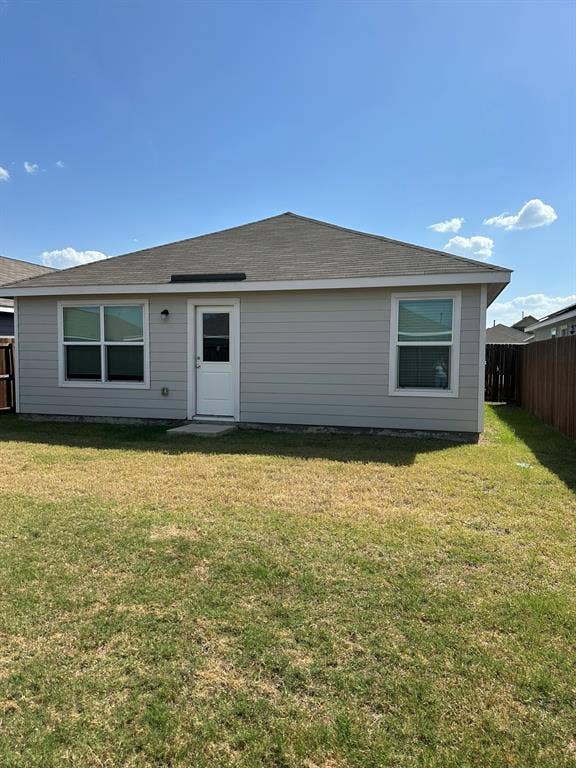 5705 Manarchos Lane, Forney, TX 75126 Back of property featuring a shingled roof