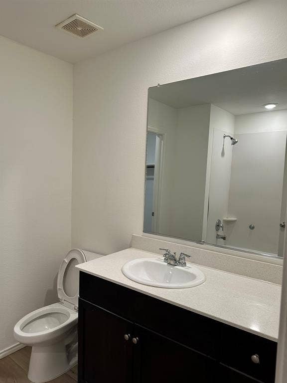 5705 Manarchos Lane, Forney, TX 75126 Bathroom with vanity, wood finished floors, and a shower