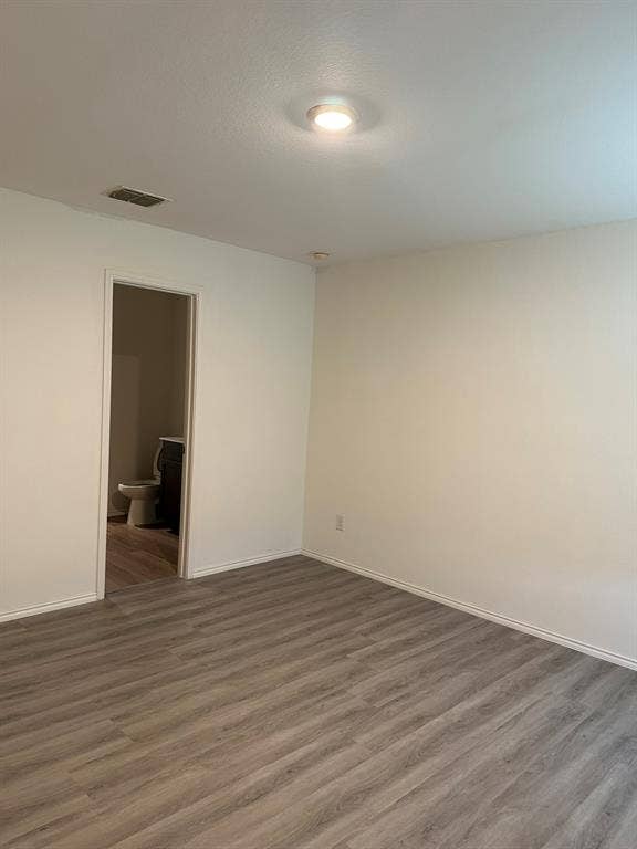 5705 Manarchos Lane, Forney, TX 75126 Spare room featuring wood finished floors and a textured ceiling