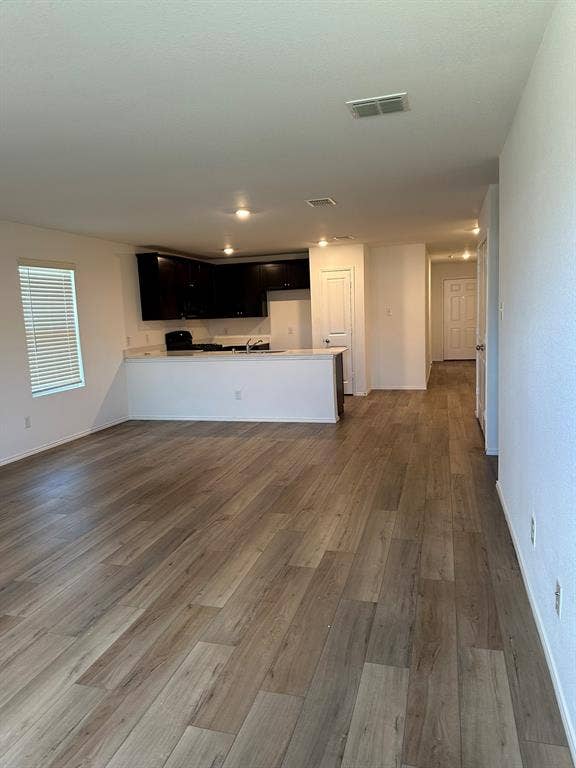 5705 Manarchos Lane, Forney, TX 75126 Unfurnished living room featuring wood finished floors and recessed lighting