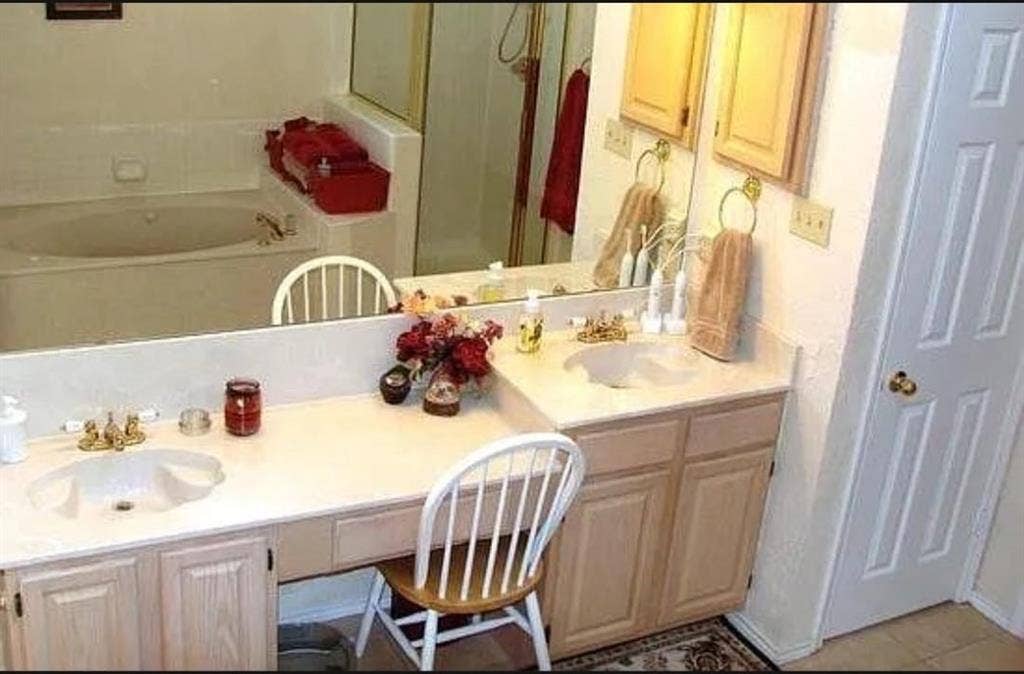 550 Village Green Drive, Coppell, TX 75019 Dual vanity with integrated sinks, light wood-finish cabinetry, and a full-width mirror