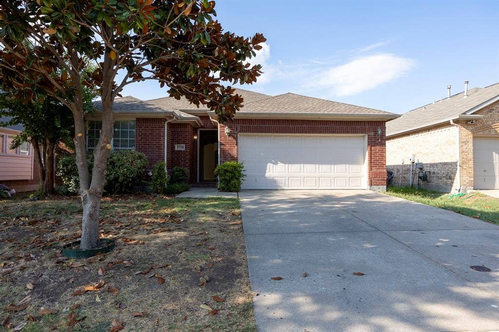5728 Calloway Drive, McKinney, TX 75070 Brick exterior with a gabled roof and attached two-car garage