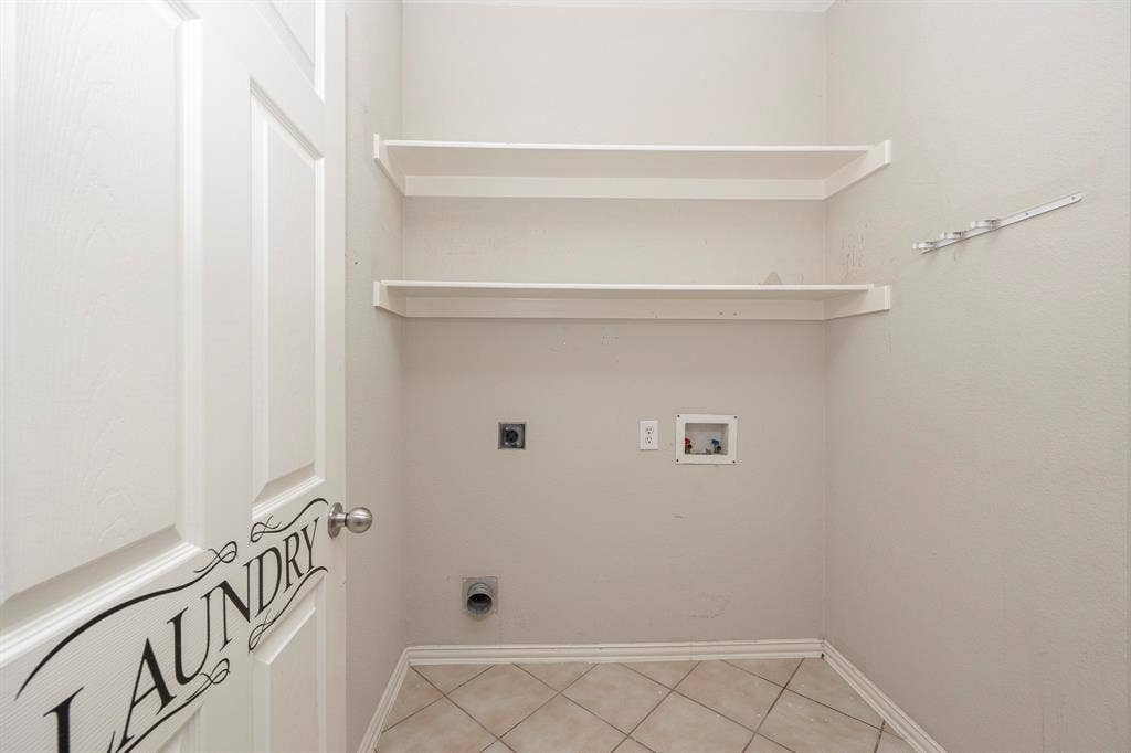 5728 Calloway Drive, McKinney, TX 75070 Tile flooring, two integrated wall shelves, laundry hookups, and a panel door