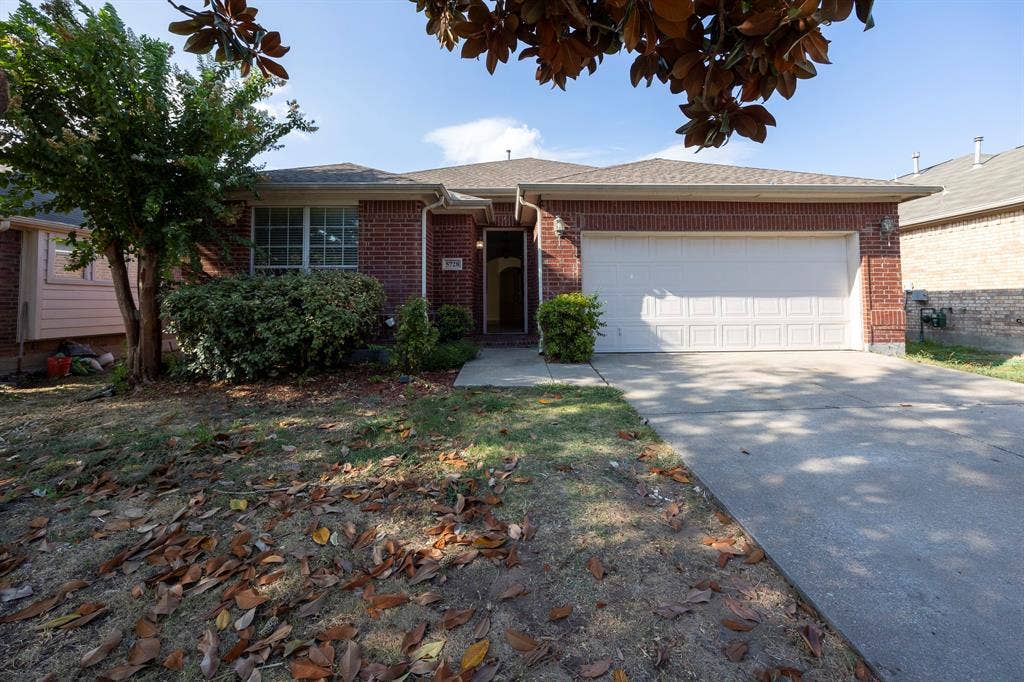 5728 Calloway Drive, McKinney, TX 75070 Brick exterior, attached two-car garage with paneling, concrete driveway, and front landscaping