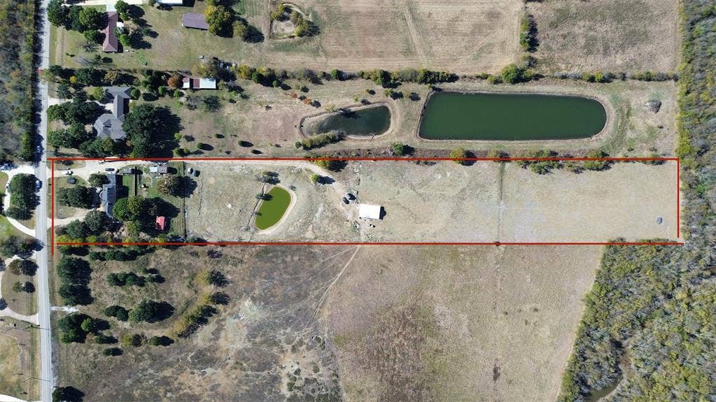 363 town east, Sunnyvale, TX 75182 View of rural area with property parcel outlined and a large body of water