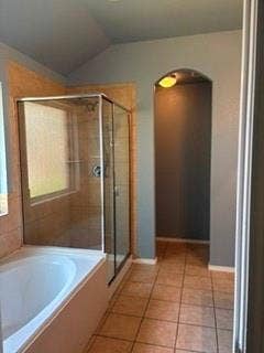 1316 Shelley Drive, Burleson, TX 76028 Tiled shower enclosure with clear glass door, built-in bathtub, and archway architectural detail