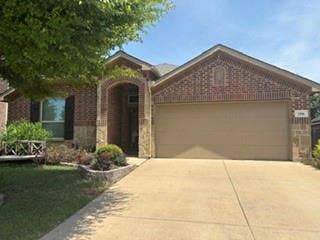 1316 Shelley Drive, Burleson, TX 76028 Brick and stone facade with an arched entry