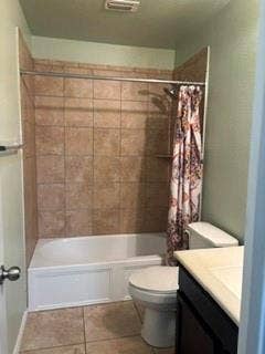 1316 Shelley Drive, Burleson, TX 76028 Ceramic tile flooring, built-in bathtub, ceramic tile shower surround, shower head, and toilet with an adjacent vanity