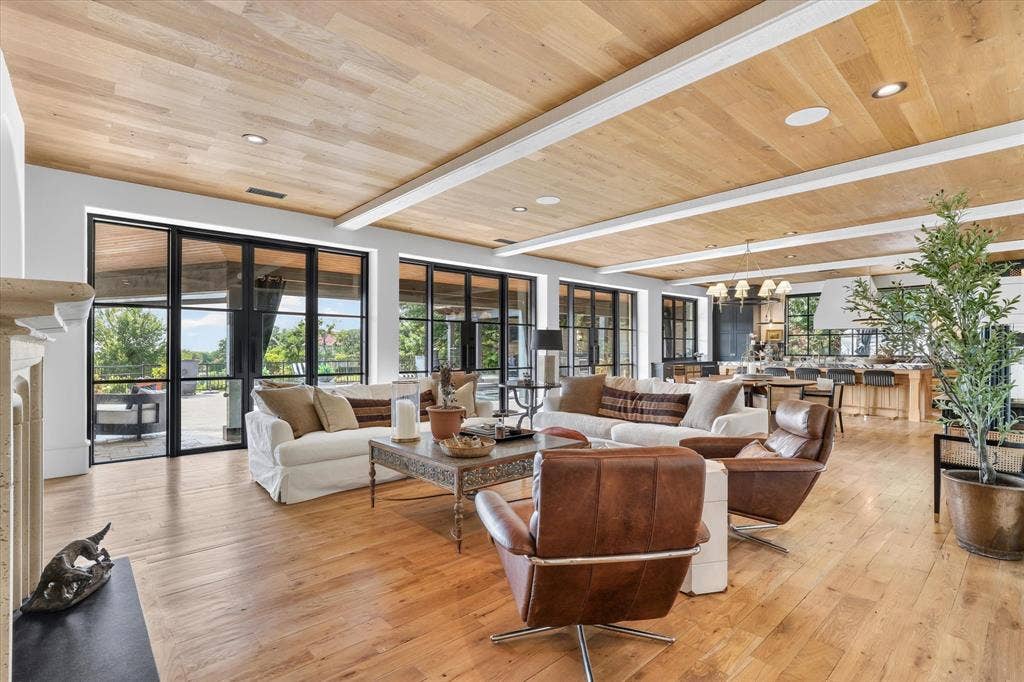 5 SAVANNAH Circle, Frisco, TX 75034 Expansive family room where warm wood ceilings and walls of modern windows and doors create a seamless connection to the outdoors.