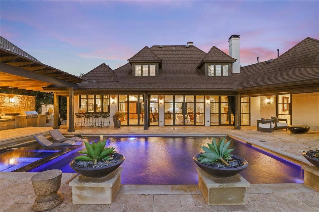 5 SAVANNAH Circle, Frisco, TX 75034 Resort-style outdoor living with pool, expansive terraces and walls of windows connecting the home to the outdoors.