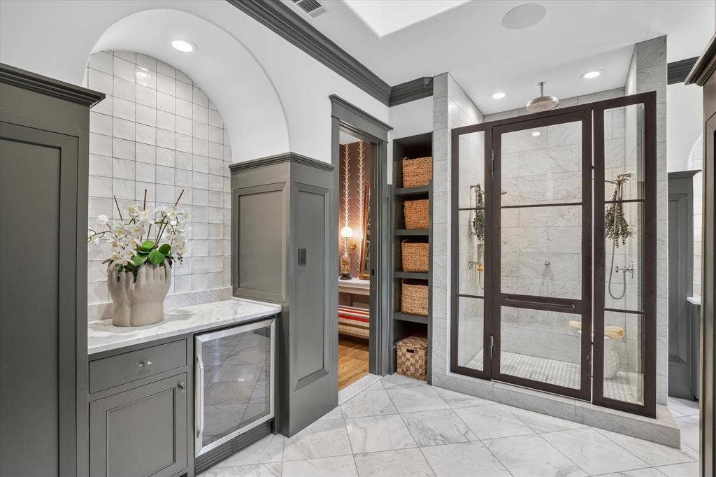 5 SAVANNAH Circle, Frisco, TX 75034 Dramatic glass-enclosed shower and custom cabinetry elevate the primary bath with boutique-hotel style.