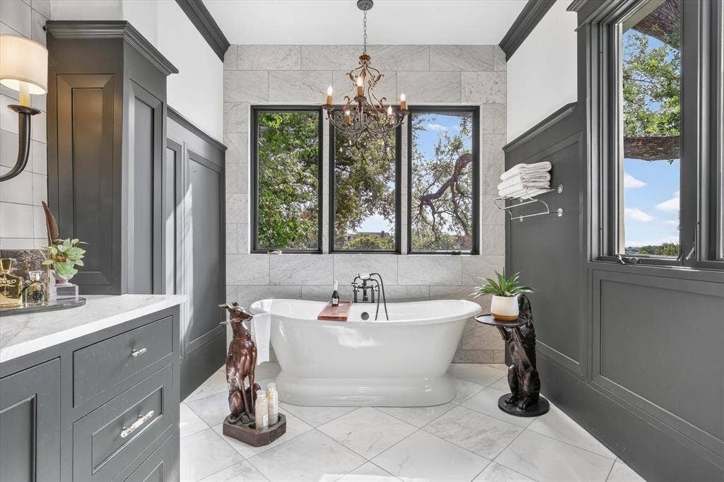 5 SAVANNAH Circle, Frisco, TX 75034 Freestanding soaking tub creates a luxurious focal point beneath windows overlooking the private grounds.