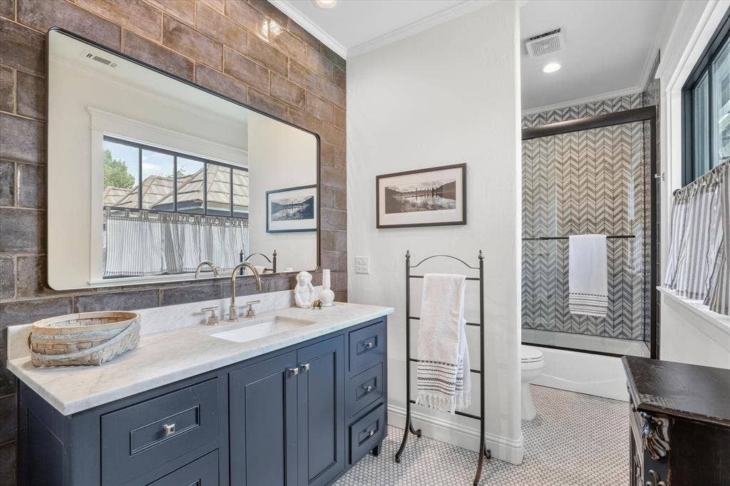 5 SAVANNAH Circle, Frisco, TX 75034 Beautifully updated bath with custom cabinetry, designer finishes and a striking tiled shower.