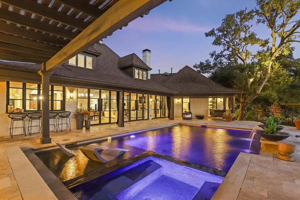 5 SAVANNAH Circle, Frisco, TX 75034 Evening lighting showcases the pool, spa and beautifully integrated outdoor living spaces.