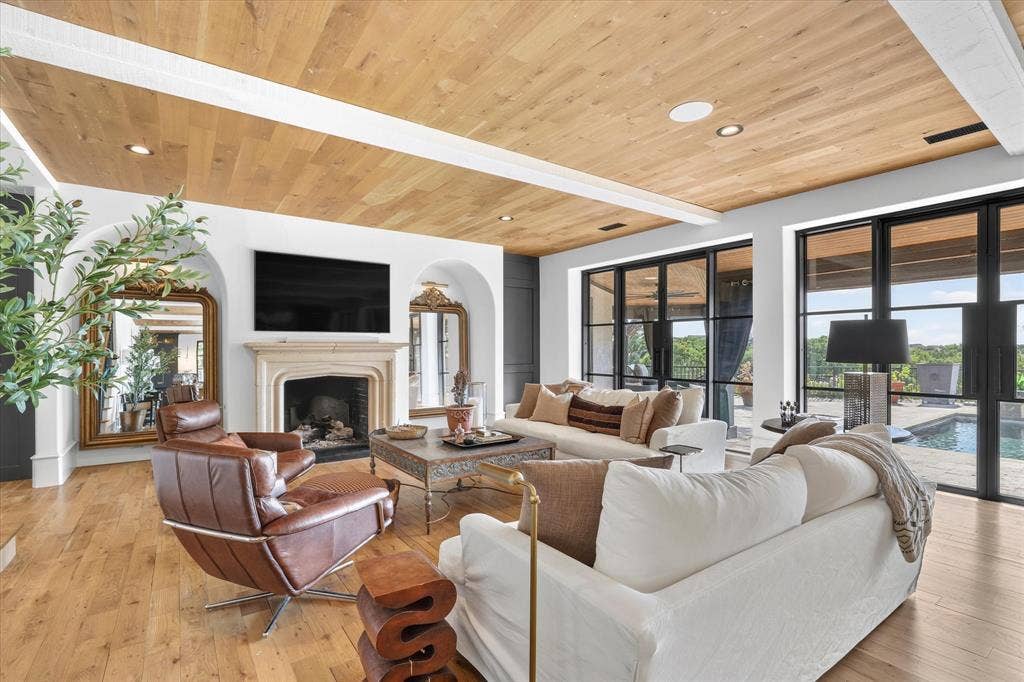 5 SAVANNAH Circle, Frisco, TX 75034 Fireplace anchors the inviting family room, surrounded by beautiful architectural details and views of the pool.