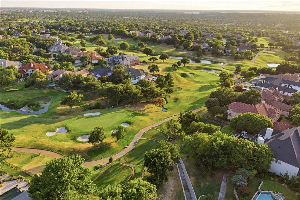 5 SAVANNAH Circle, Frisco, TX 75034 A spectacular aerial perspective showcases the surrounding golf course and lush Stonebriar Village setting.
