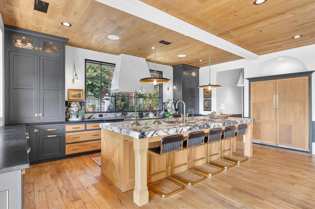 5 SAVANNAH Circle, Frisco, TX 75034 An impressive island provides abundant prep space and seating while anchoring the open-concept kitchen.