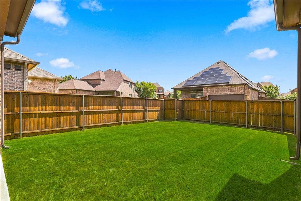 Expansive lawn area with a perimeter wood fence