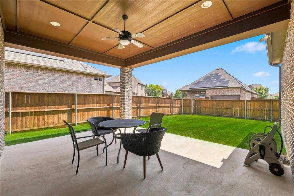 Expansive concrete patio with a full wooden ceiling, recessed lighting, and a ceiling fan