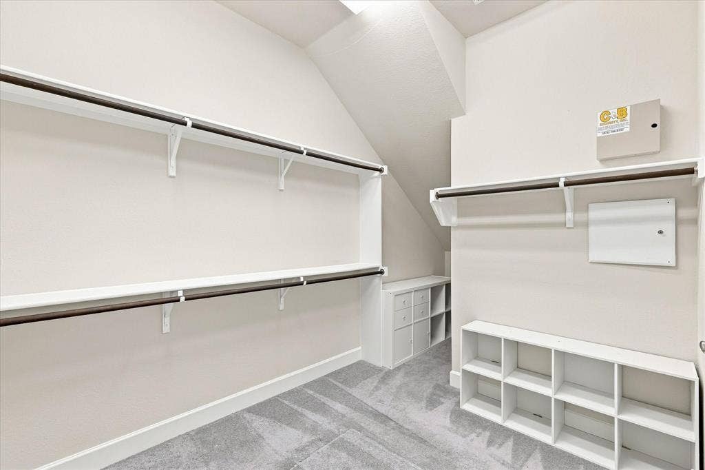 Angled ceiling lines, integrated shelving, built-in storage cubbies, and garment rods