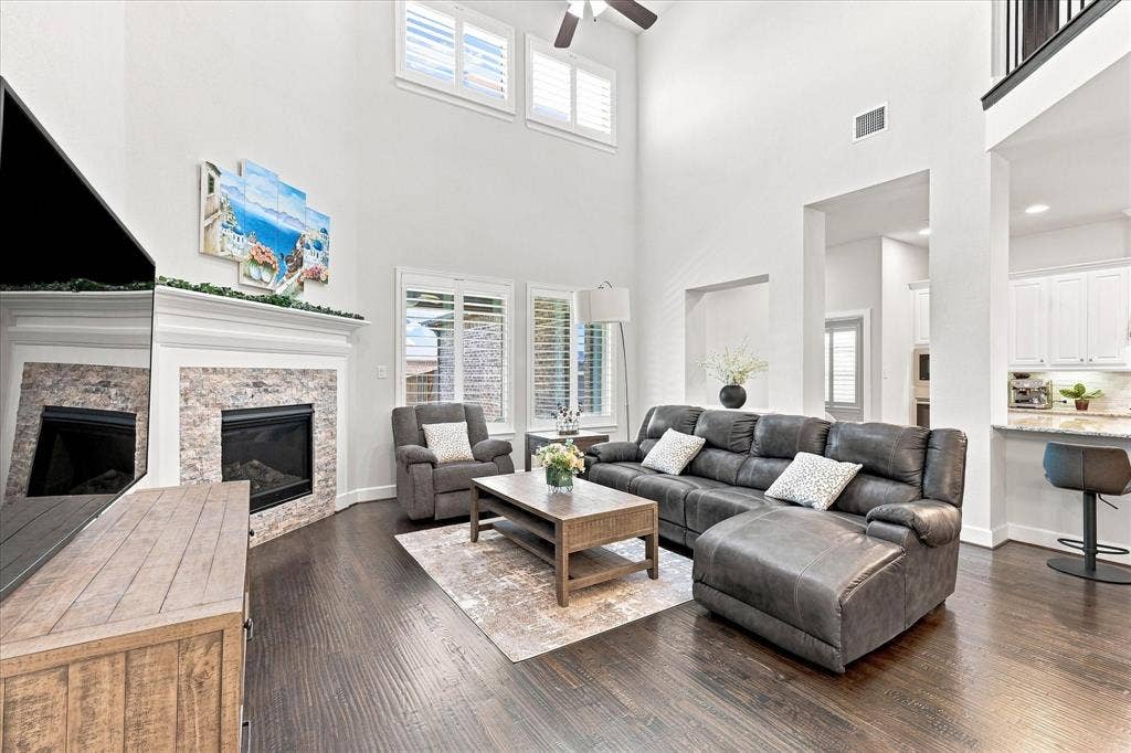 Soaring two-story living room with high ceilings and abundant natural light from transom windows