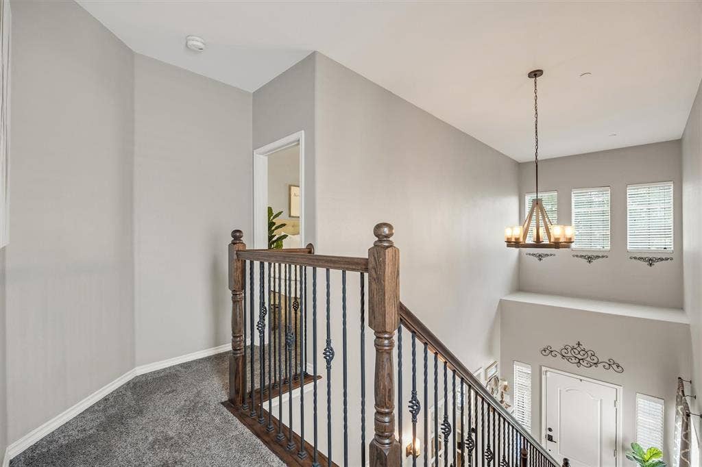 Area at top of stairs with view of Primary bedroom