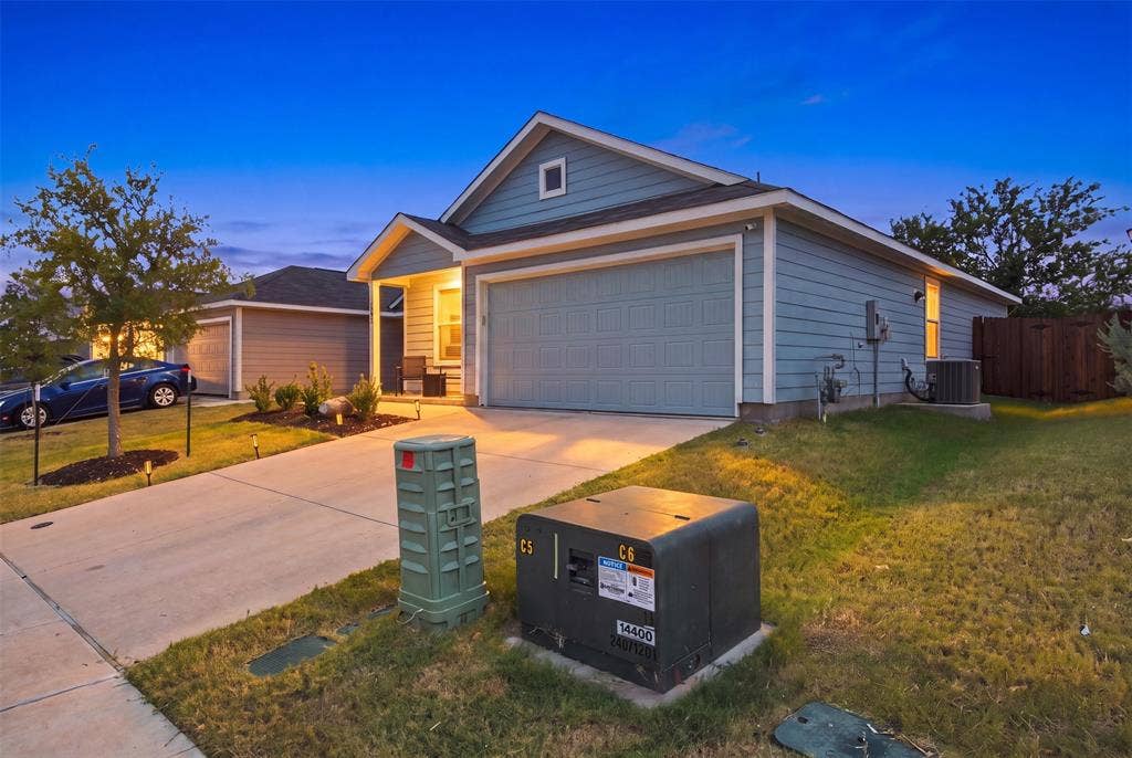 3409 Flicker Lane, McKinney, TX 75071 Siding exterior with a covered porch entry, attached garage, and concrete driveway