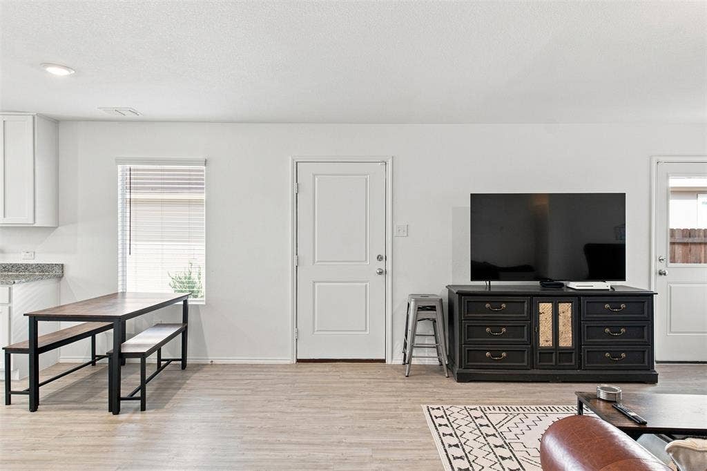 3409 Flicker Lane, McKinney, TX 75071 Recessed ceiling lighting, wood-finish flooring, white paneled doors, and a built-in kitchen counter with a light-toned surface