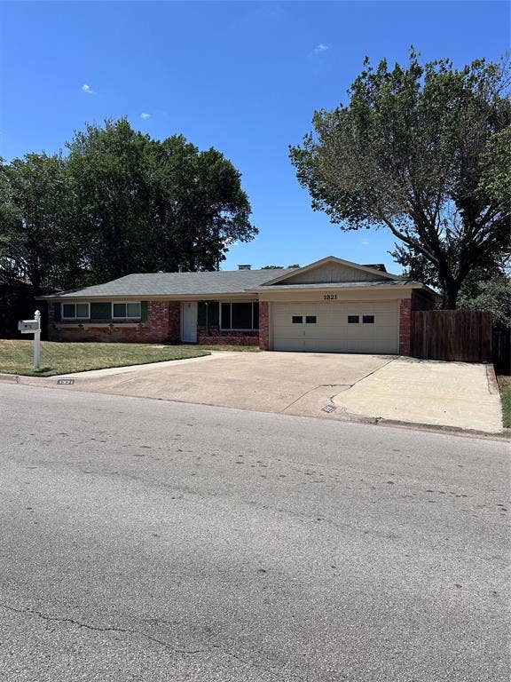1321 Hurstview Drive, Hurst, TX 76053 Brick facade with a two-car garage