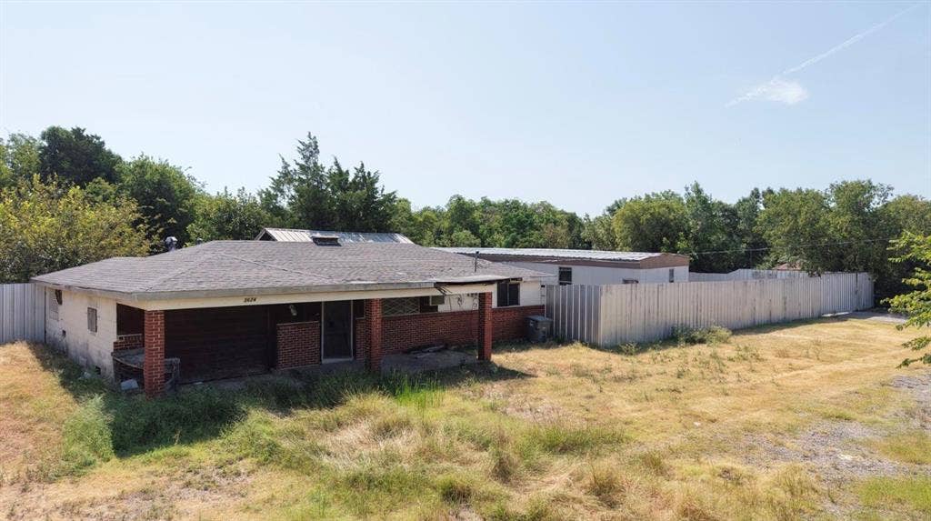 3624 S Ledbetter Drive, Dallas, TX 75236 Brick façade with an integrated covered porch, a shingle roof, and a privacy fence