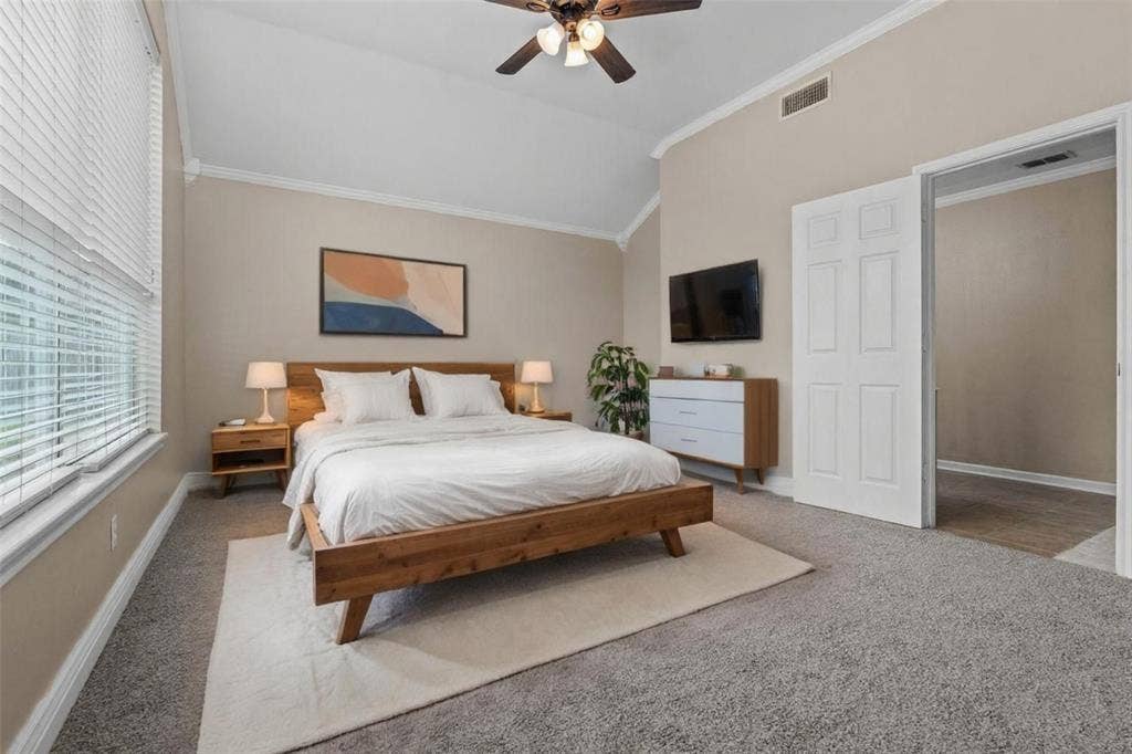 833 Greenwood Circle, Lindale, TX 75771 Spacious primary bedroom featuring a wood-frame bed, neutral wall finishes, carpet flooring, and a large area rug
