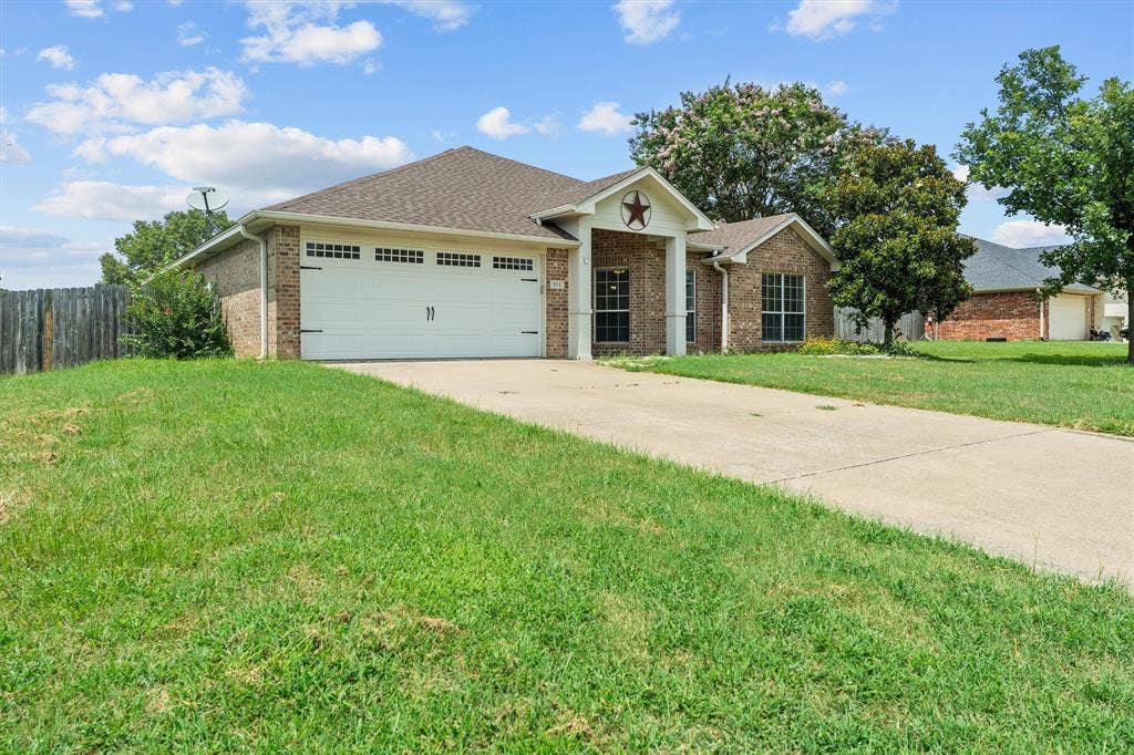 833 Greenwood Circle, Lindale, TX 75771 Welcoming brick exterior with arched entryway and decorative star accent