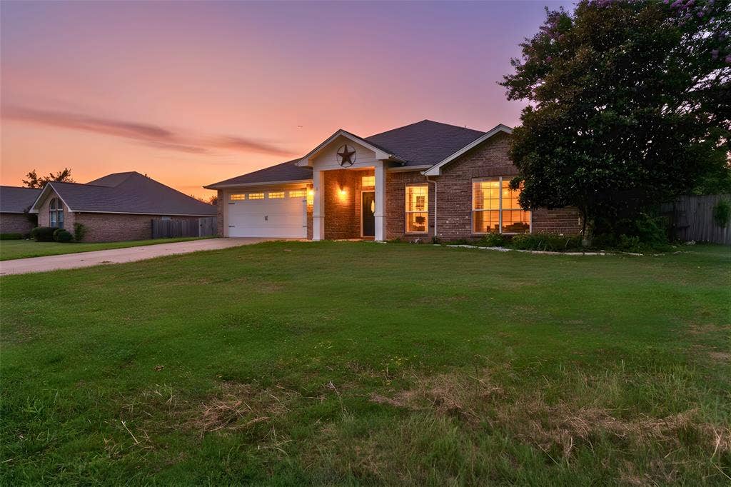 833 Greenwood Circle, Lindale, TX 75771 Brick exterior with a dark roof and white trim