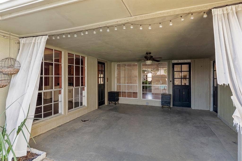 1116 Windsong Trail, Richardson, TX 75081 Covered patio featuring a ceiling fan, multiple large windows, and a glass-paneled door