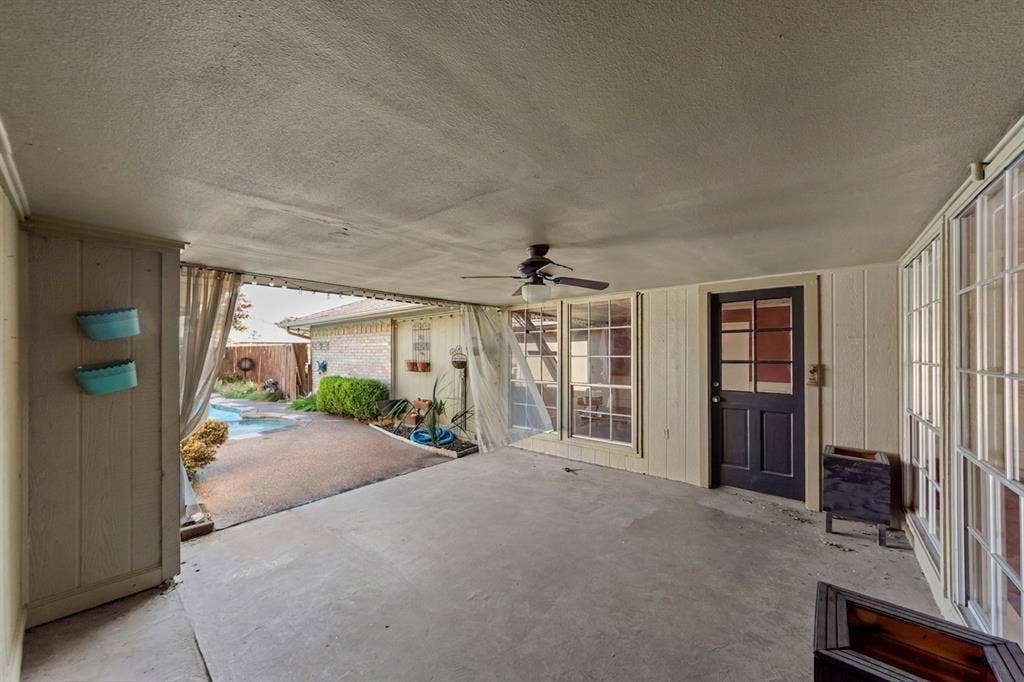 1116 Windsong Trail, Richardson, TX 75081 Covered patio featuring a concrete slab, ceiling fan, and multiple window panels