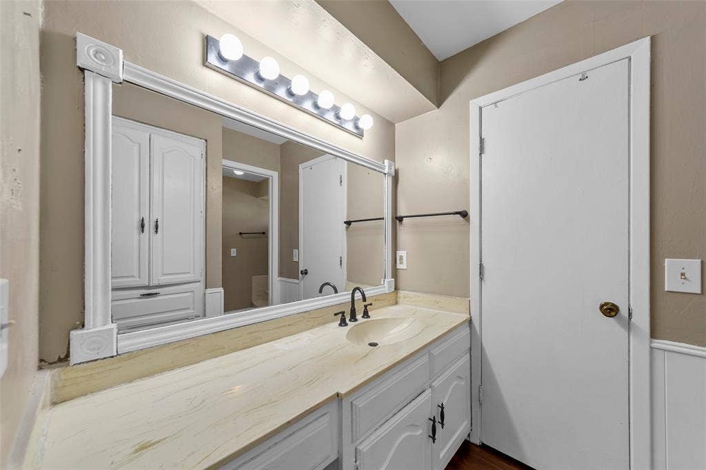 1116 Windsong Trail, Richardson, TX 75081 Vanity with a built-in sink, framed mirror, and integrated lighting