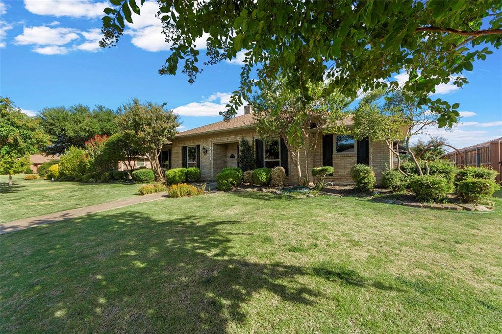 1116 Windsong Trail, Richardson, TX 75081 Brick exterior, manicured lawn, established landscaping, walkway, mature trees