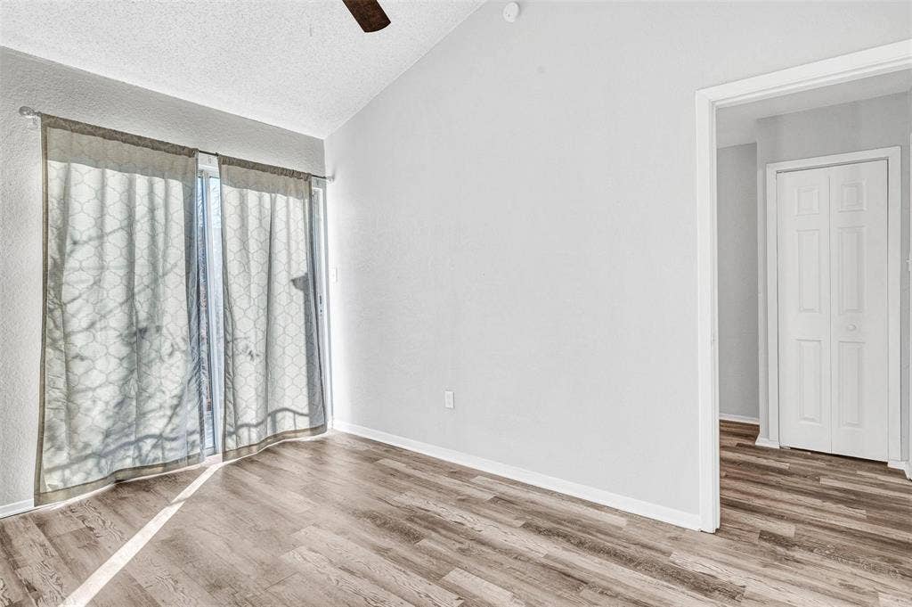 2500 E Park Boulevard, #P2, Plano, TX 75074 Primary bedroom with ceiling fan and balcony access.