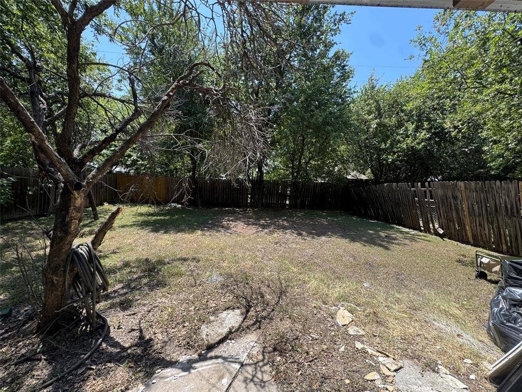 8105 White Settlement Road, White Settlement, TX 76108 Expansive backyard featuring mature trees and wood fencing