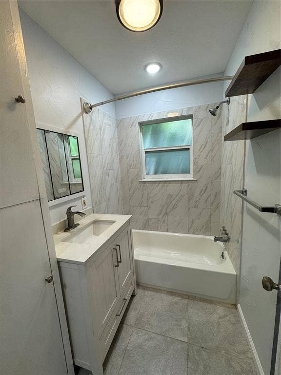 8105 White Settlement Road, White Settlement, TX 76108 White vanity with integrated sink and chrome faucet, tile flooring, and a bathtub with tile surround